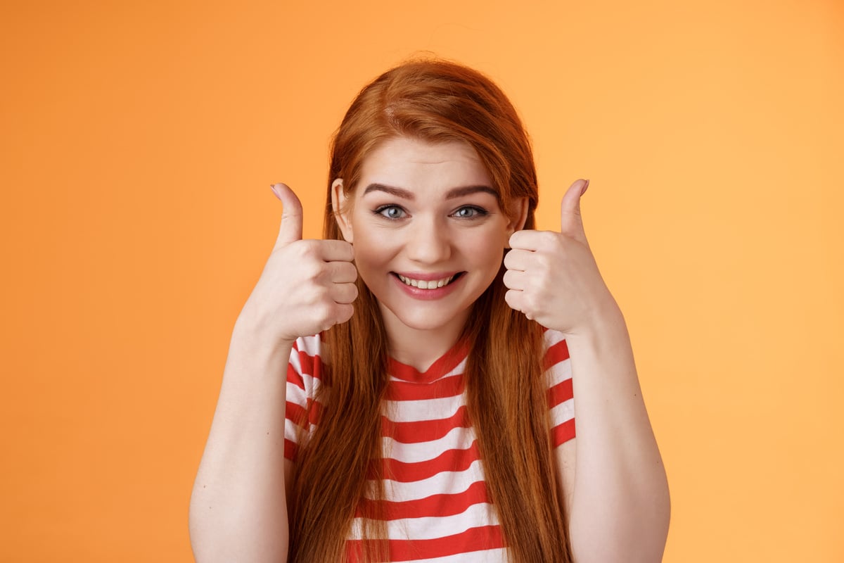 Hopeful Cheerful Cute Redhead Girlfriend Rooting for You, Believe Win, Smiling Supportive Satisfied, Show Thumbs-up Delighted, Approve Choice, Wish Good Luck, Encourage Friend, Orange Background