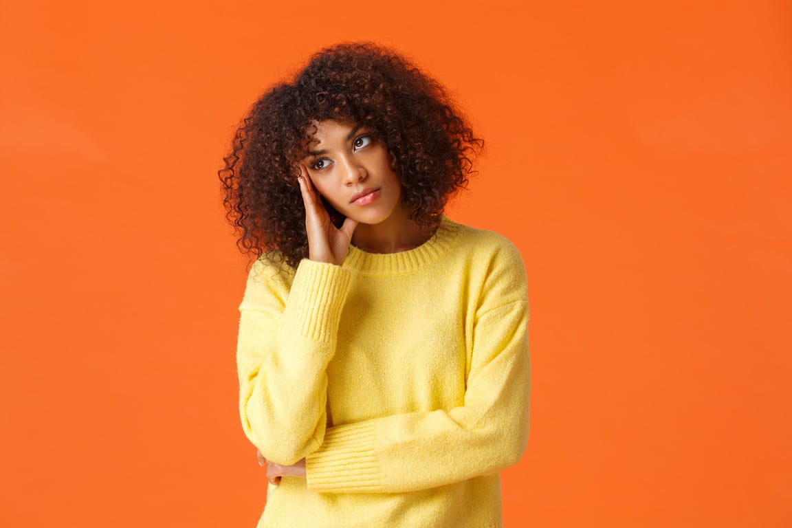 Uninterested Bored African-American Woman in Yellow Sweater, Facepalm, Looking Away with Uninterested, Skeptical Expression, Attend Boring Party, Standing Upset and Unsatisfied over Orange Background